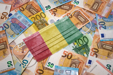 Medical mask with the flag of Guinea on a variety of european banknotes.(series)
