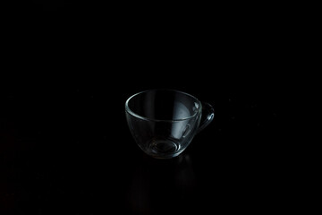 transparent glass cup on a dark background.