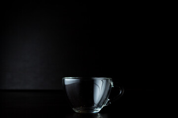 transparent glass cup on a dark background.