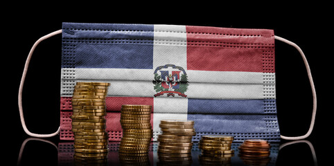 Medical mask with the flag of Dominican Republic behind some shrinking stacks of various coins.(series)
