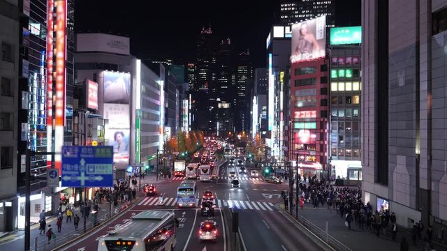 Shinjuku, one the busiest place in Tokyo at night. Asian city life filmed in 4K, blurred logos