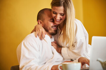 Cheerful wife distracting her husband from work