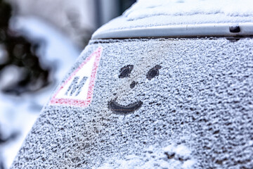 Frozen windshield in the snow with a heart