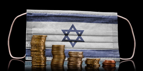 Medical mask with the flag of Israel behind some shrinking stacks of various coins.(series)