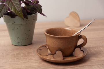 Tea cup with wooden hearts for St Valentine date concept
