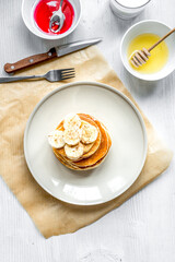 cooked pancake on plate top view at wooden background