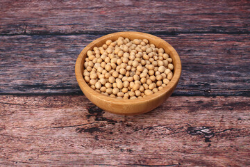 Soya bean in wooden bowl on rustic wood background