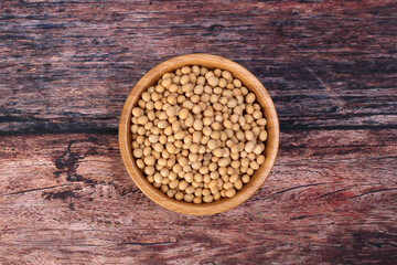 Soya bean in wooden bowl on rustic wood background