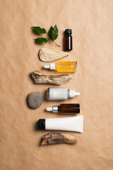 Serum bottles natural organic cosmetic with green leaf on brown