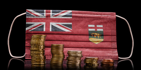 Medical mask with the flag of Manitoba behind some shrinking stacks of various coins.(series)