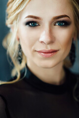 Blonde girl with blue eyes in a black dress © omelnickiy