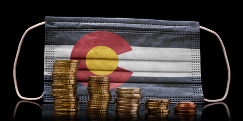 Medical mask with the flag of Colorado behind some shrinking stacks of various coins.(series)