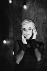 Blonde girl with blue eyes in a black dress © omelnickiy