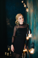 Blonde girl with blue eyes in a black dress © omelnickiy