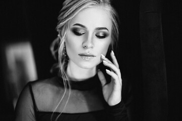 Blonde girl with blue eyes in a black dress © omelnickiy