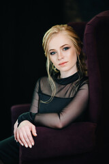 Blonde girl with blue eyes in a black dress © omelnickiy
