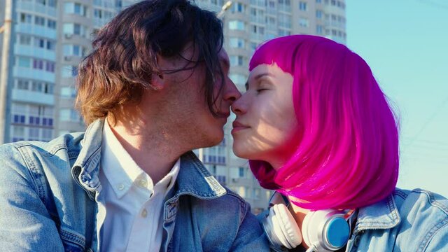 A young romantic couple is spending time outdoors. Hipsters in love on a date. The concept of youth culture and love relationships