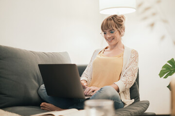 Caucasian executive woman working at home office, checking email on a laptop