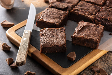 Homemade pieces of brownies on black background