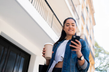 Young woman using her mobile phone.