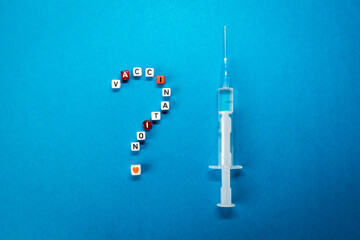 Question mark made of vaccination word and a syringe on blue background. Pros and cons, yes or no...