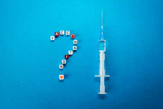 Question Mark Made Of Vaccination Word And A Syringe On Blue Background. Pros And Cons, Yes Or No For Coronavirus Vaccine, Concerns About COVID-19 Vaccine Concept