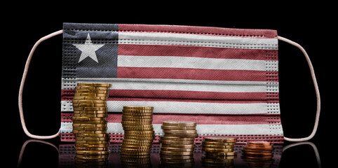 Medical mask with the flag of Liberia behind some shrinking stacks of various coins.(series)