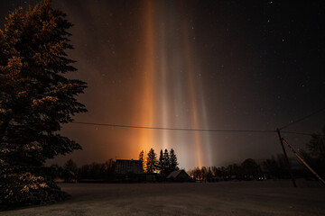 Light Pillars result from a rare meteorological phenomena. Winter nature landscape.
