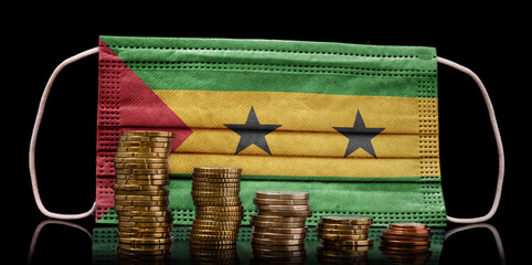 Medical mask with the flag of Sao Tome and Principe behind some shrinking stacks of various coins.(series)