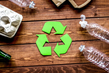 environment concept with recycling symbol on wooden background top view