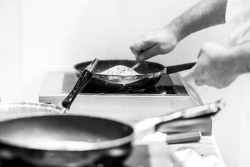 Chef cooking in a kitchen, chef at work, Black and White.