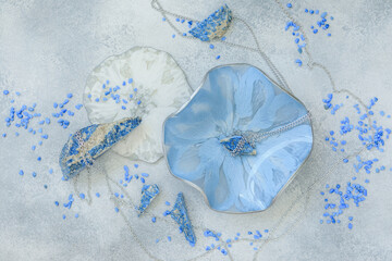 Composition with resin art plates and natural blue stones on gray background. Flat lay