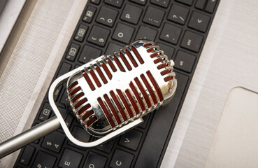 Vintage microphone closeup on keyboard - vlog and podcast concept