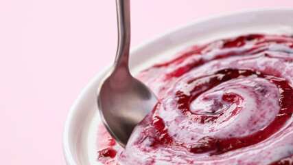 Yogurt with fruit jam, curd cream swirl with berry topping