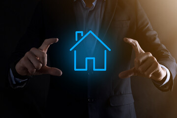 Real estate concept, businessman holding a house icon.House on Hand.Property insurance and security concept. Protecting gesture of man and symbol of house.