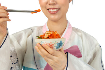 Partial view of Women wearing Korean Hanbok dress eating Kimchi kimgee isolate on white background.