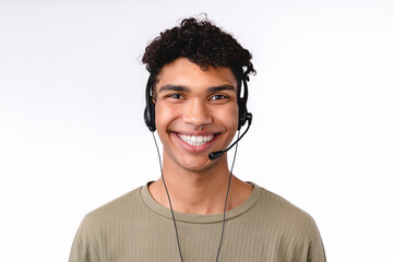 Cheerful young man in dispatcher`s headset isolated over white background