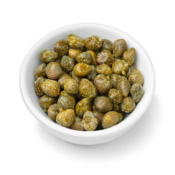 Bowl with pickled capers close up on white background