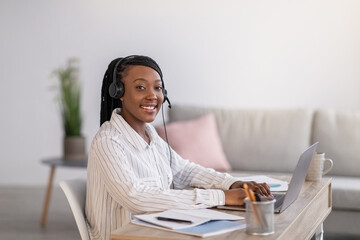 Pretty black woman listening to webinar from home
