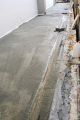 unfinish concrete walk way around new house. grunge and dirty wet cement material.