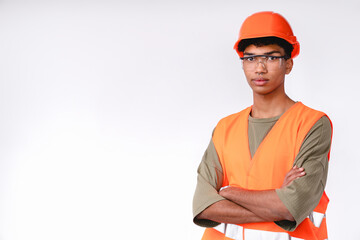 Serious young construction worker in uniform and hard hat isolated over white background