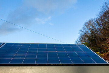 Naklejka premium Solar panel in low autumn light on a clear day in Scotland, United Kingdom
