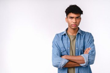 Offended young mixed-race man in casual clothes isolated over white background