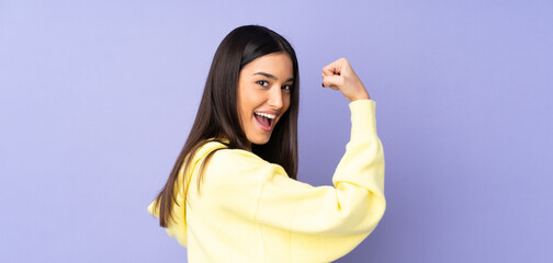 Young caucasian woman over isolated background doing strong gesture