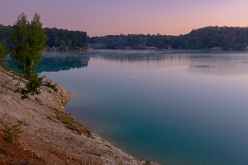 Naklejka na ściany i meble A beautiful turquoise lake. Quarry with turquoise water.