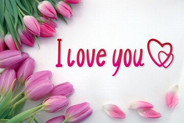 Pink tulips decoration and hearts on white background. Valentine's Day card.