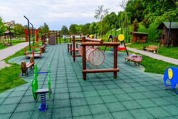 Fototapeta na wymiar Different equipment on children playground in a city park