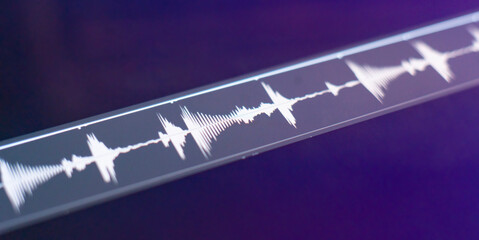 macro view of the computer monitor screen with sound audio wave graph volume