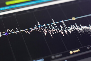 macro view of the computer monitor screen with sound audio wave graph volume