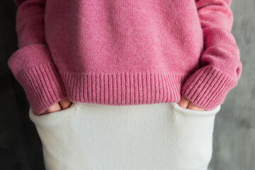 Pink warm sweater and white skirt with pockets